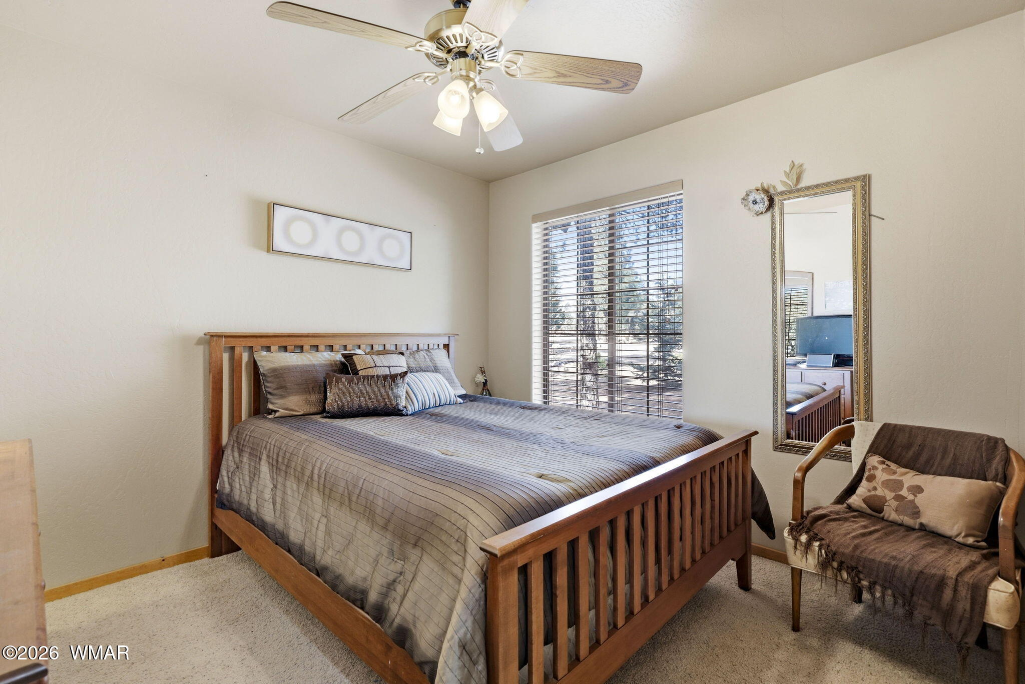 2337 Puma Circle Overgaard, AZ 85933 - Photo 16 of 35 a bedroom with a bed and a chandelier