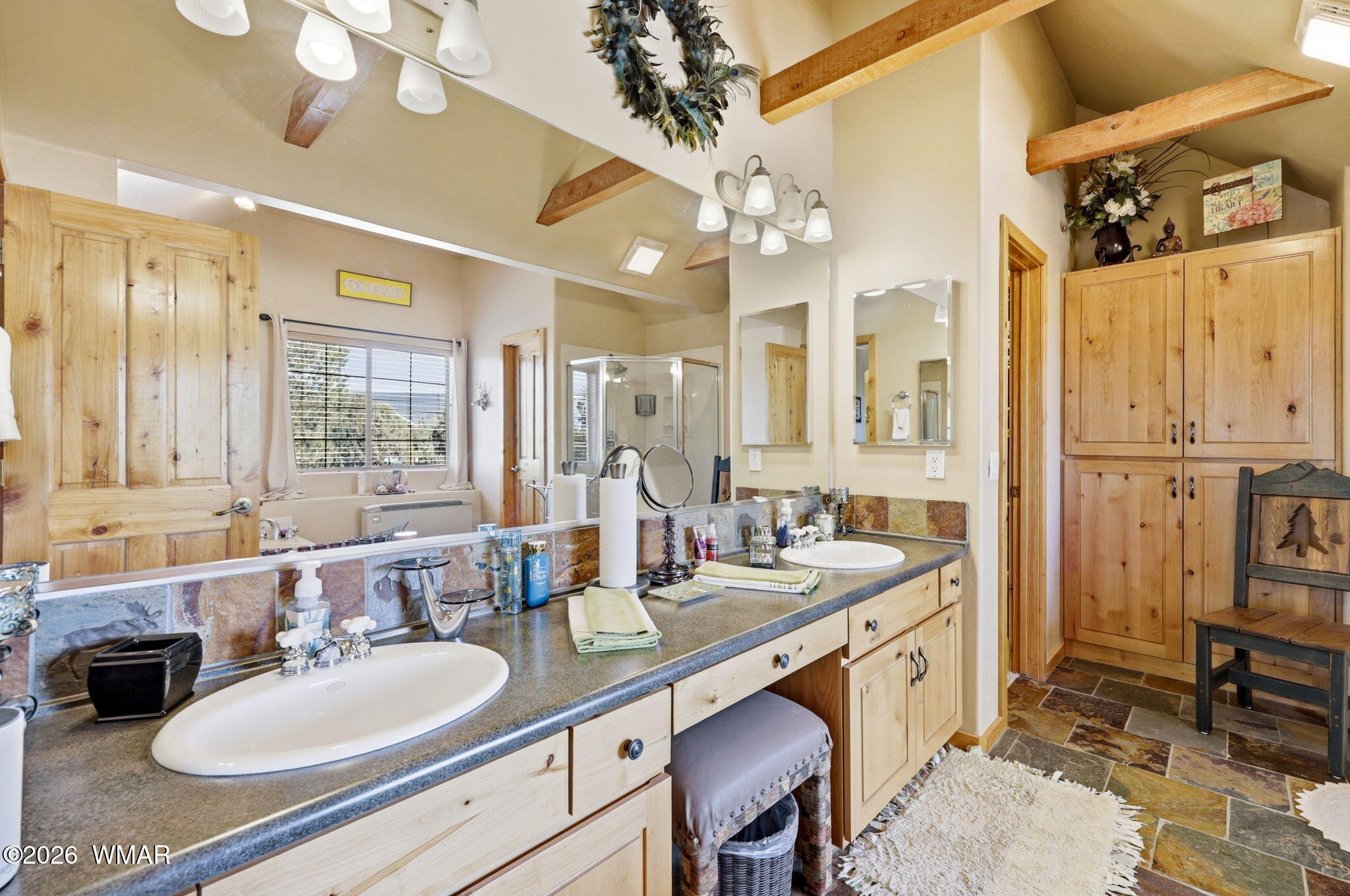 2337 Puma Circle Overgaard, AZ 85933 - Photo 21 of 35 a bathroom with a granite countertop double vanity sink a mirror and a shower