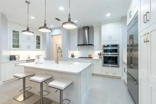 a kitchen with a sink a counter space appliances and cabinets