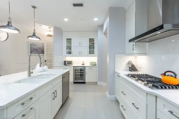 a kitchen with a sink a stove and a wooden cabinets