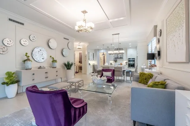 a living room with furniture and a chandelier