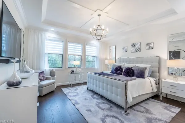 a living room with a bed furniture and a large window