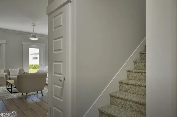 a view of a livingroom with furniture and entryway wooden floor and windows