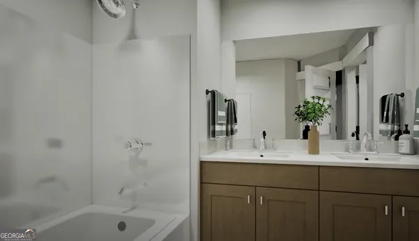 a bathroom with a bathtub sink double vanity and mirror