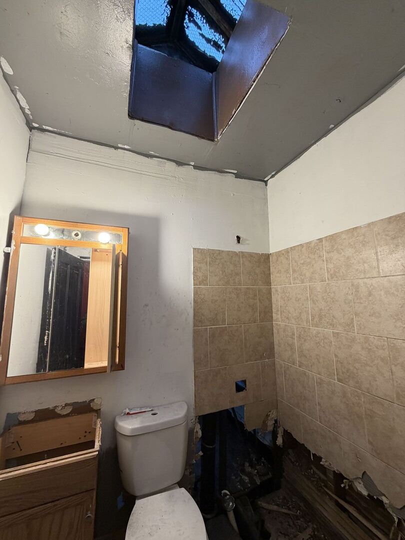 207 South Troy Street Chicago, IL 60612 - Photo 13 of 30 a bathroom with a toilet sink and mirror