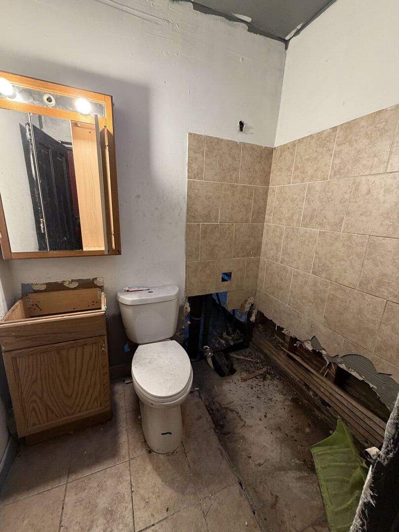 207 South Troy Street Chicago, IL 60612 - Photo 14 of 30 a bathroom with a granite countertop toilet sink and mirror