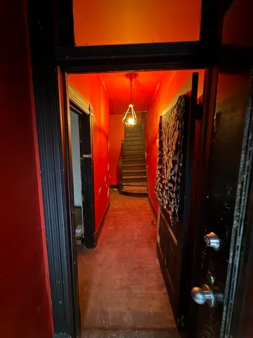 a view of a workspace with furniture and wooden floor