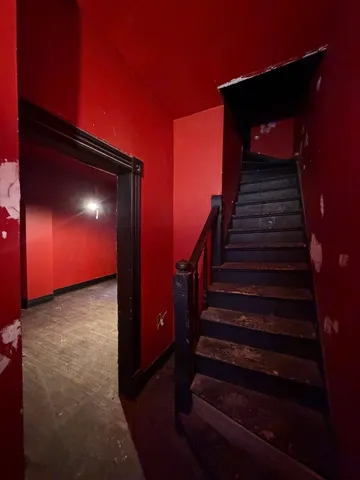 a view of an empty room with yellow lighting