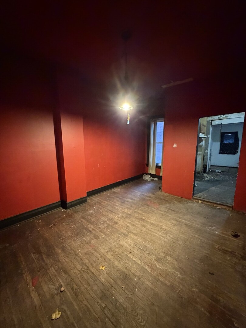 207 South Troy Street Chicago, IL 60612 - Photo 6 of 30 a view of an empty room with yellow lighting