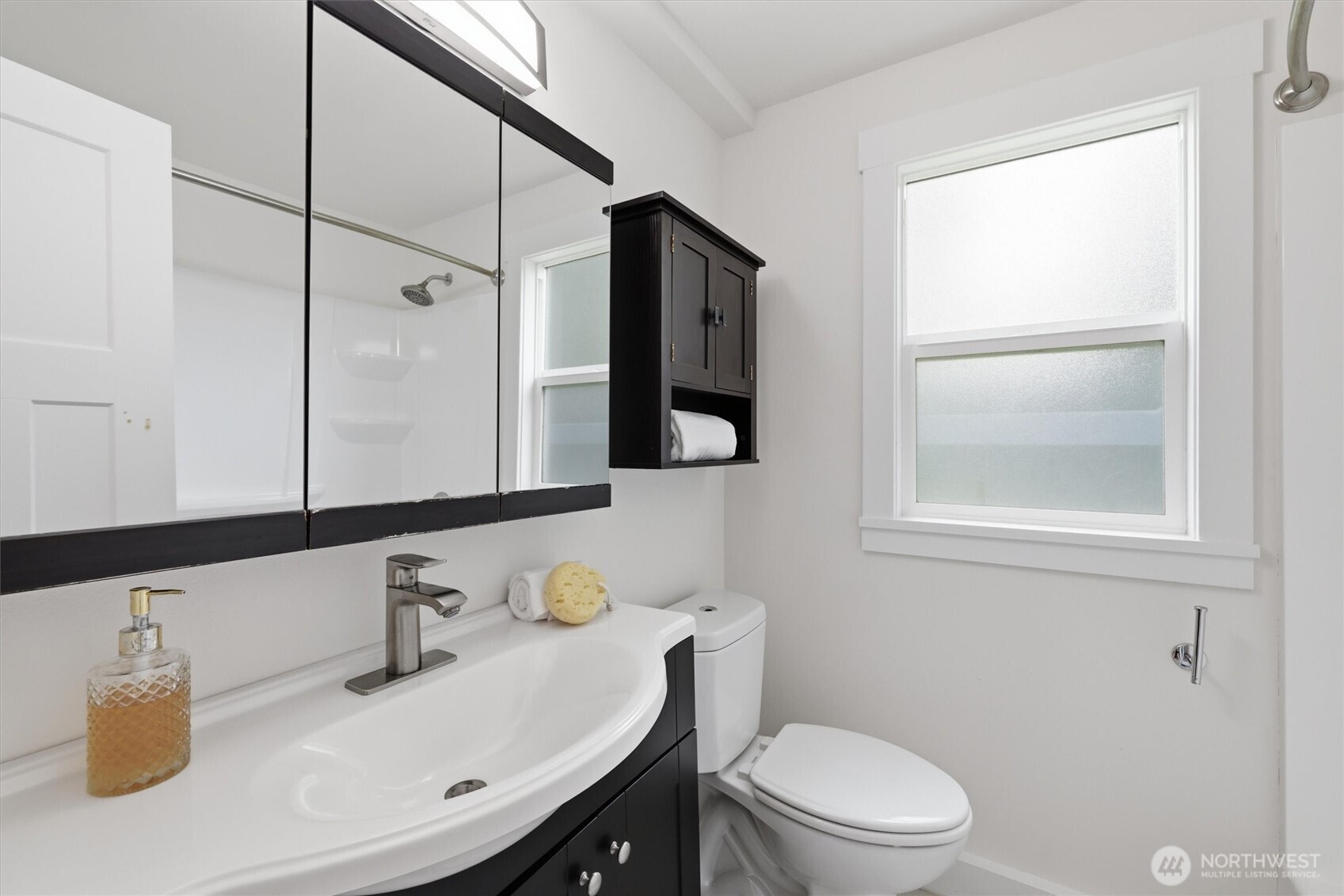 1651 Southwest 114th Street Seattle, WA 98146 - Photo 25 of 37 a bathroom with a sink toilet vanity and mirror