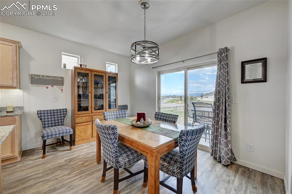 9642 Timberlake Loop Colorado Springs, CO 80927 - Photo 17 of 46 a view of a dining room with furniture window and wooden floor