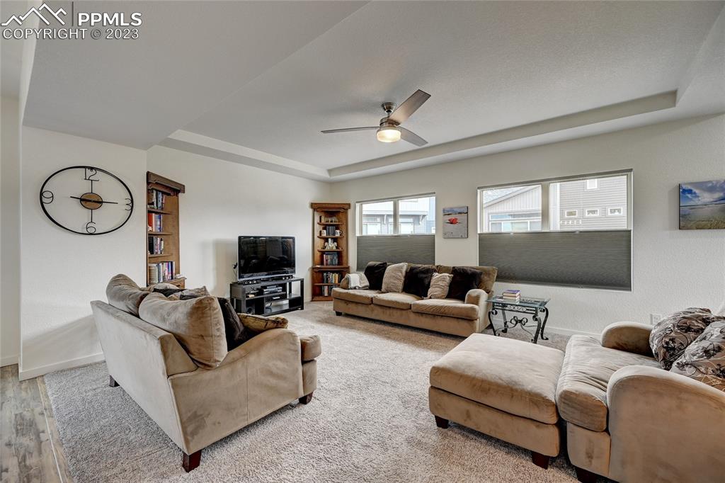 9642 Timberlake Loop Colorado Springs, CO 80927 - Photo 23 of 46 a living room with furniture and a flat screen tv