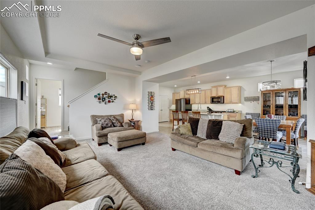 9642 Timberlake Loop Colorado Springs, CO 80927 - Photo 25 of 46 a living room with furniture and a view of kitchen