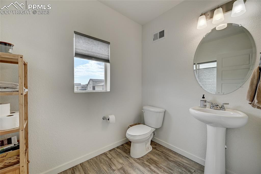 9642 Timberlake Loop Colorado Springs, CO 80927 - Photo 26 of 46 a bathroom with a toilet sink and mirror