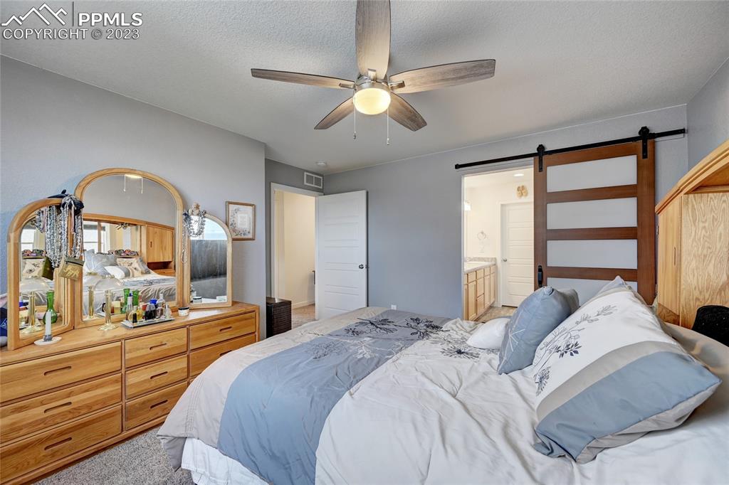 9642 Timberlake Loop Colorado Springs, CO 80927 - Photo 29 of 46 a bedroom with a large bed and a large window