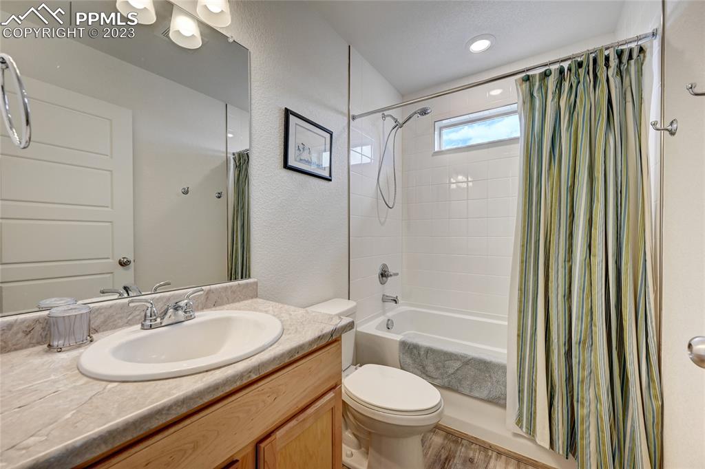 9642 Timberlake Loop Colorado Springs, CO 80927 - Photo 36 of 46 a bathroom with a granite countertop sink toilet and shower