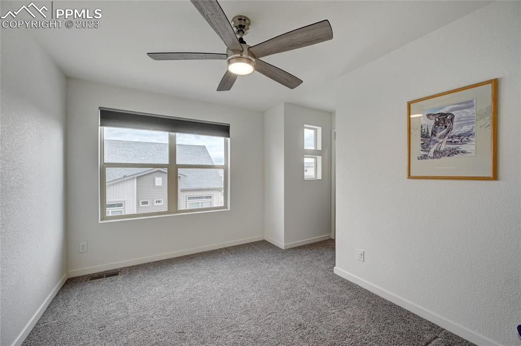 9642 Timberlake Loop Colorado Springs, CO 80927 - Photo 37 of 46 an empty room with windows and fan