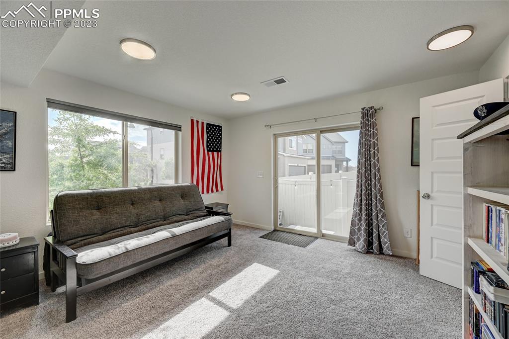 9642 Timberlake Loop Colorado Springs, CO 80927 - Photo 9 of 46 a living room with furniture and a flat screen tv