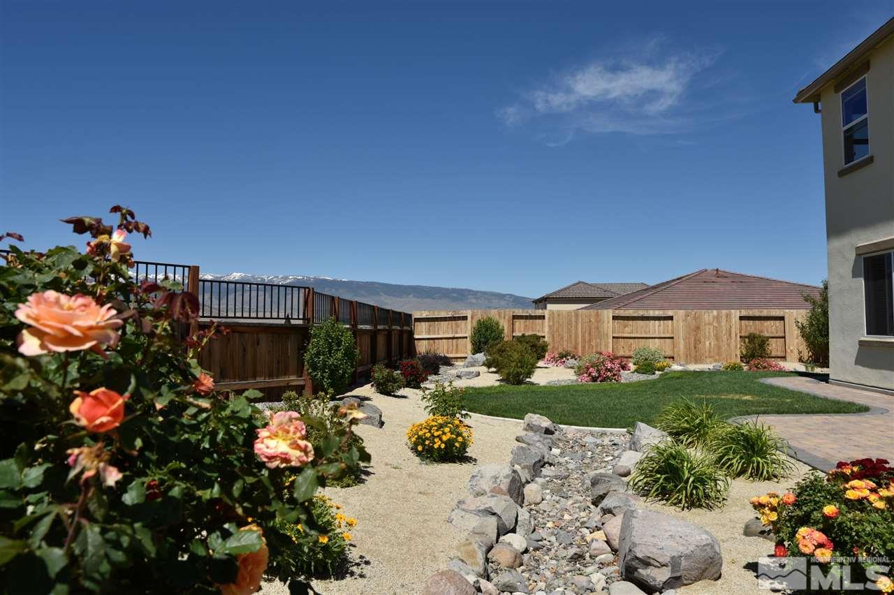 3080 Bull Rider Drive Reno, NV 89521 - Photo 15 of 21 a front view of a house with a yard and a lot of flower plants