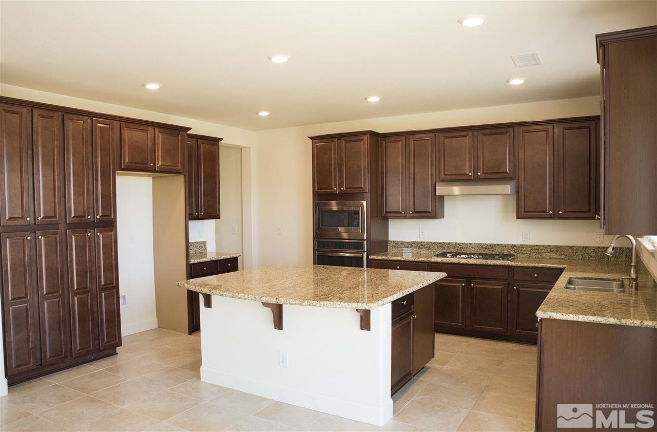3080 Bull Rider Drive Reno, NV 89521 - Photo 4 of 21 a kitchen with stainless steel appliances granite countertop a stove top oven a refrigerator a sink and dishwasher