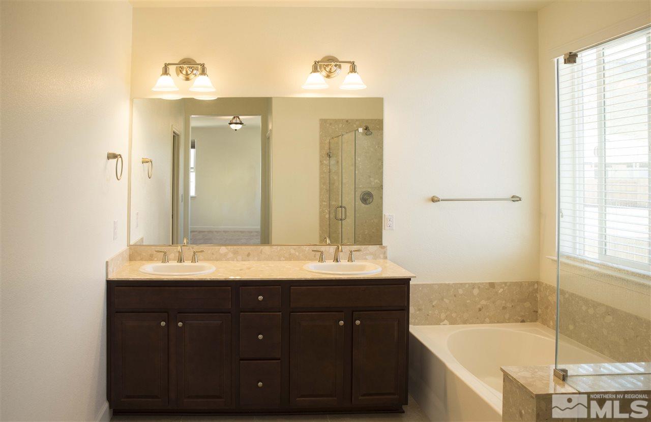 3080 Bull Rider Drive Reno, NV 89521 - Photo 8 of 21 a bathroom with a sink double vanity mirror and a bathtub
