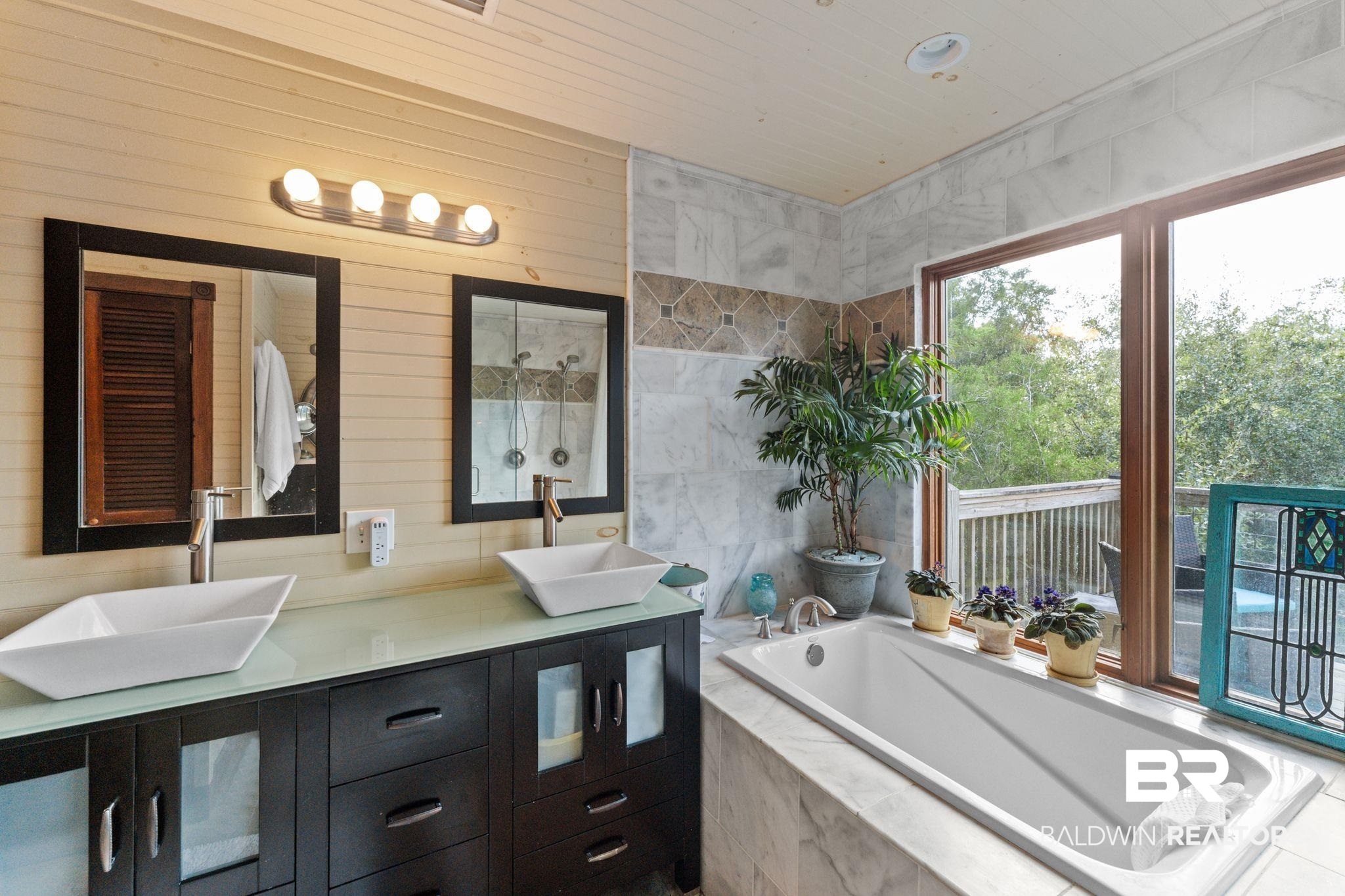 16451 Honey Road Summerdale, AL 36580 - Photo 37 of 55 Bathroom with double vanity, a bath, walk in shower, and wood walls