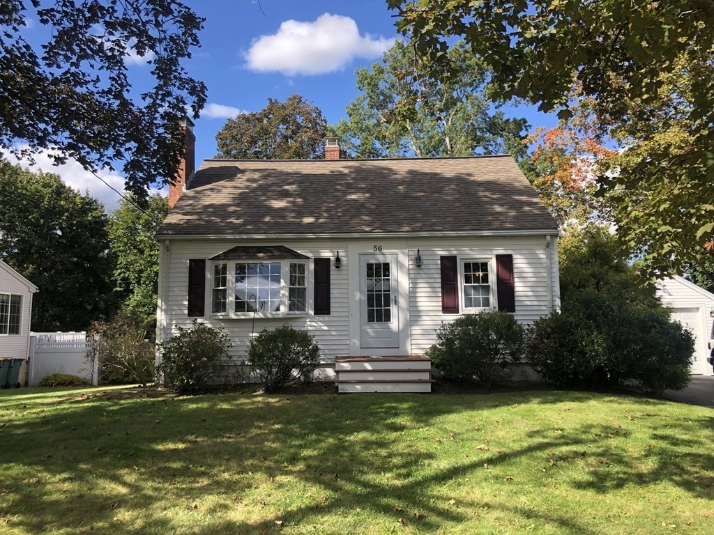 a front view of house with yard and outdoor seating