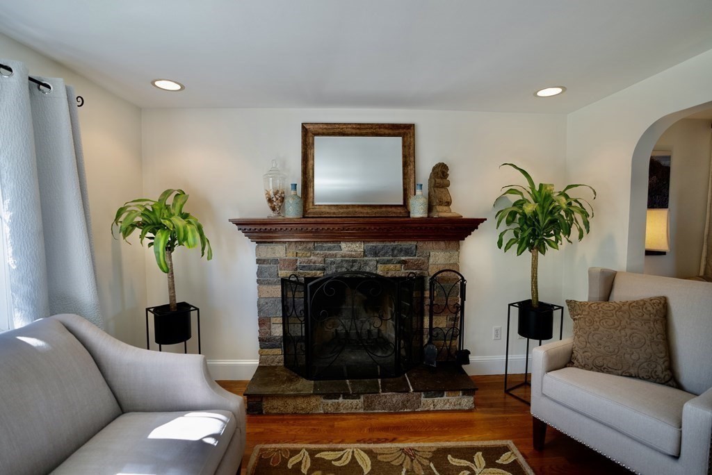 56 Bellows Circle Abington, MA 02351 - Photo 14 of 42 a living room with furniture potted plant and a fireplace