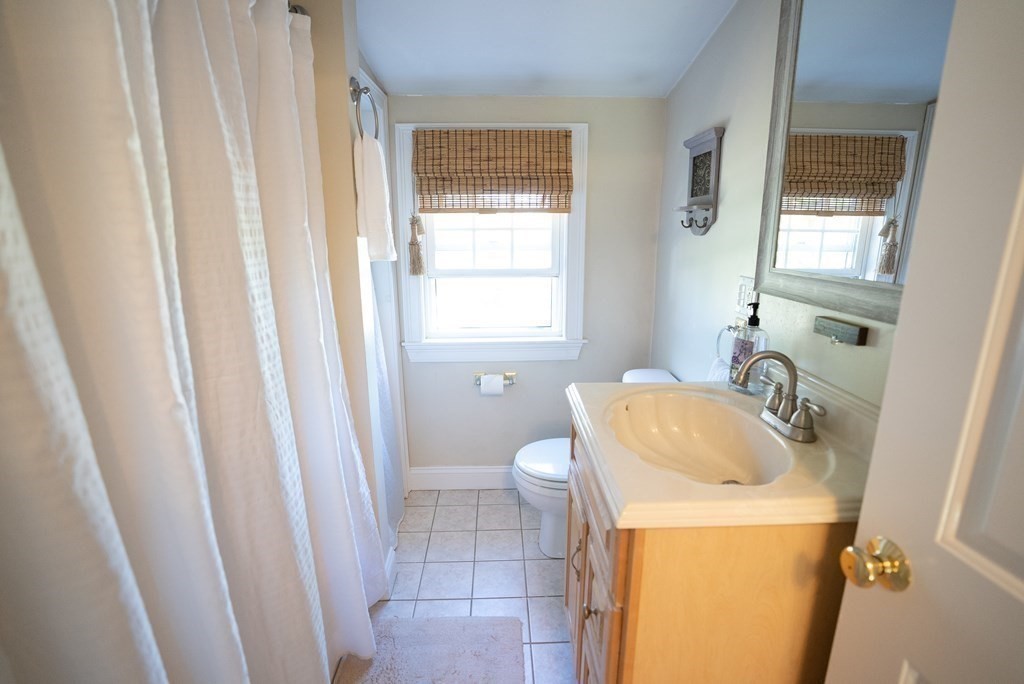 56 Bellows Circle Abington, MA 02351 - Photo 17 of 42 a bathroom with a sink toilet and window