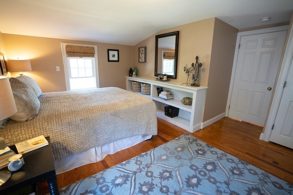 56 Bellows Circle Abington, MA 02351 - Photo 22 of 42 a bedroom with a bed and wooden floor