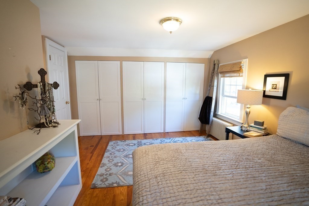 56 Bellows Circle Abington, MA 02351 - Photo 24 of 42 a bedroom with a bed and wooden floor