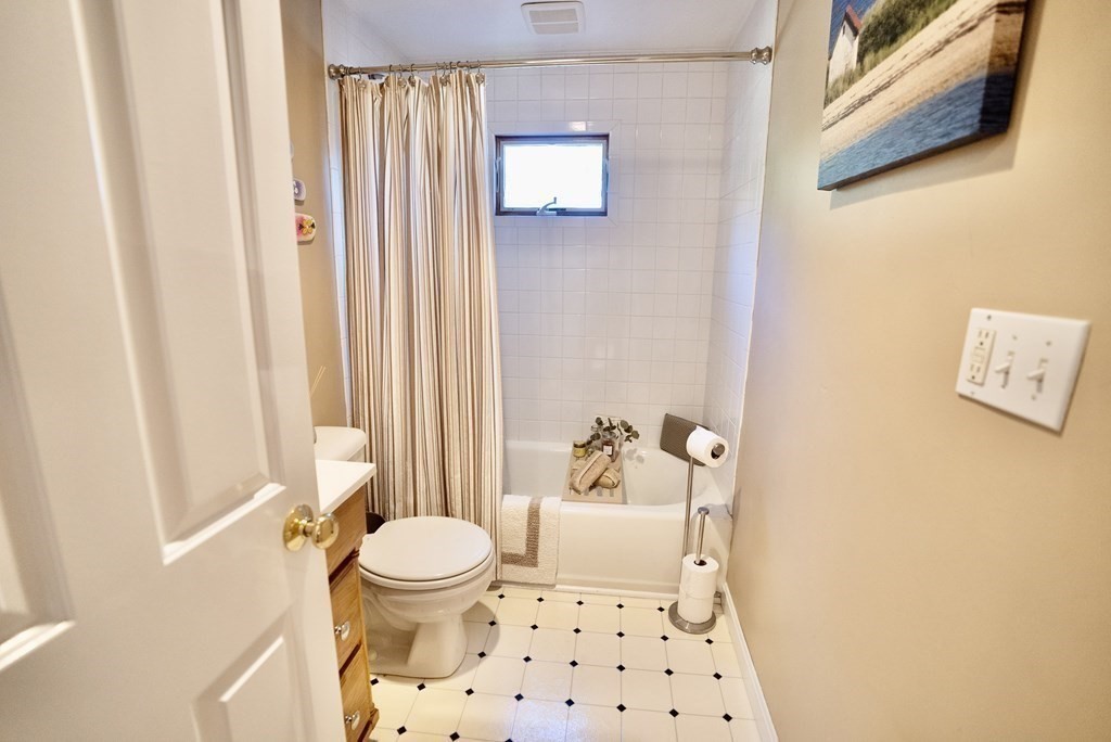 56 Bellows Circle Abington, MA 02351 - Photo 28 of 42 a bathroom with a toilet and a shower curtain