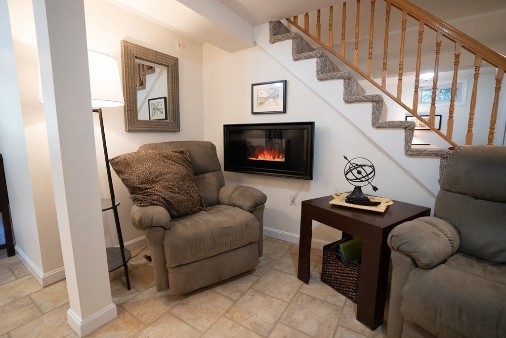 56 Bellows Circle Abington, MA 02351 - Photo 29 of 42 a living room with furniture and a fireplace