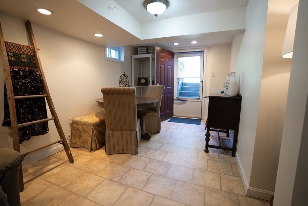 56 Bellows Circle Abington, MA 02351 - Photo 30 of 42 a living room with furniture and a flat screen tv