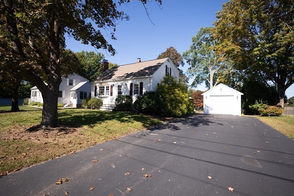 56 Bellows Circle Abington, MA 02351 - Photo 3 of 42 a front view of a house with a yard and garage
