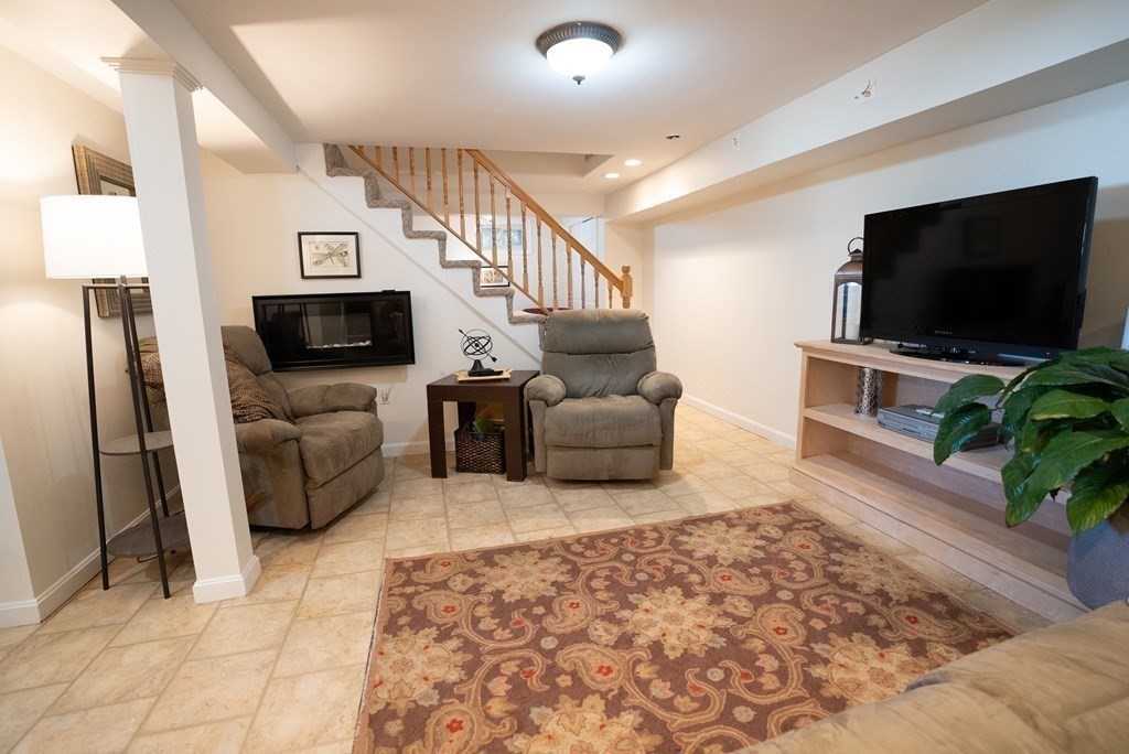 56 Bellows Circle Abington, MA 02351 - Photo 31 of 42 a living room with furniture and a flat screen tv