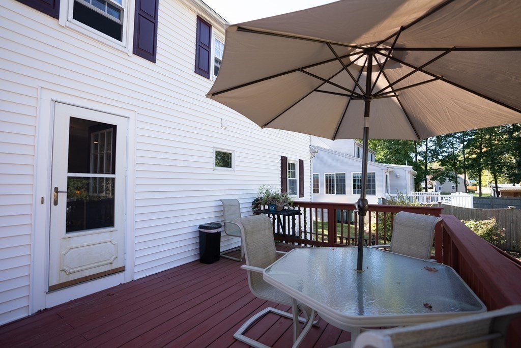 56 Bellows Circle Abington, MA 02351 - Photo 37 of 42 a view of table and chairs under an umbrella