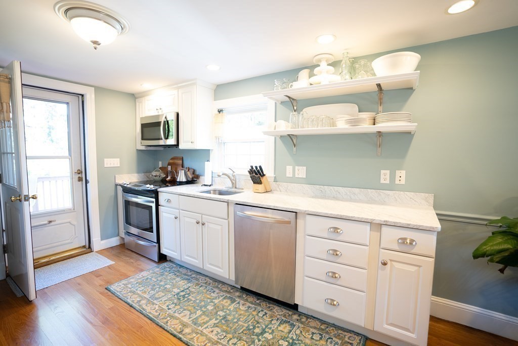 56 Bellows Circle Abington, MA 02351 - Photo 5 of 42 a kitchen with a sink cabinets and wooden floor