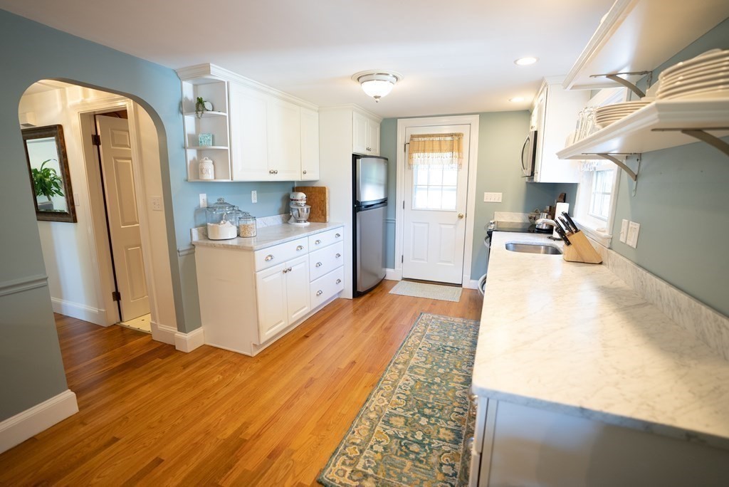 56 Bellows Circle Abington, MA 02351 - Photo 8 of 42 a kitchen with cabinets and wooden floor
