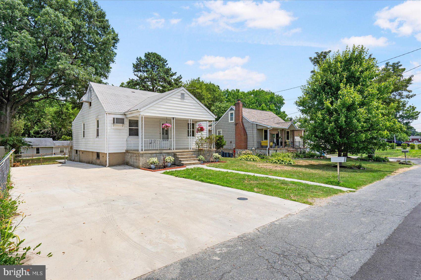 a front view of a house with a yard and porch