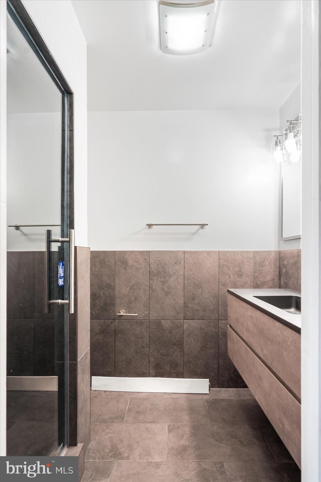 303 Miles Road Essex, MD 21221 - Photo 18 of 37 a bathroom with a shower and a sink