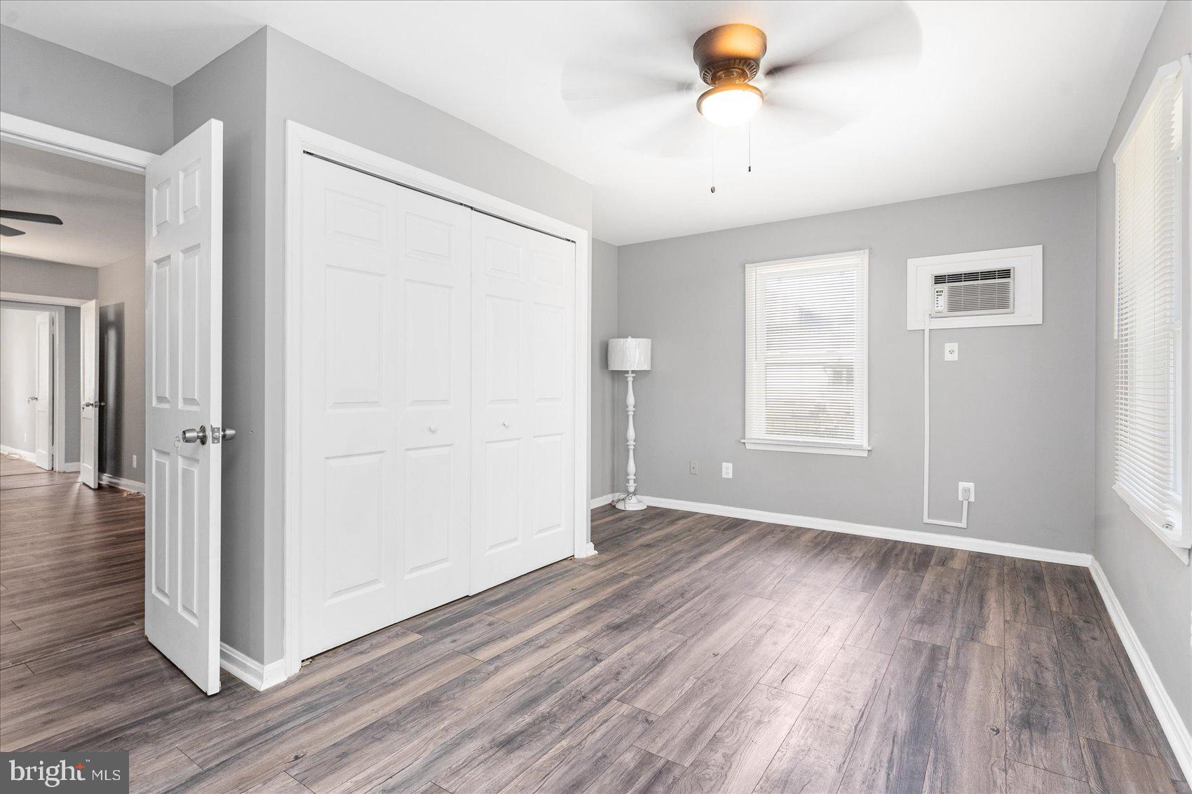 303 Miles Road Essex, MD 21221 - Photo 22 of 37 an empty room with wooden floor and windows