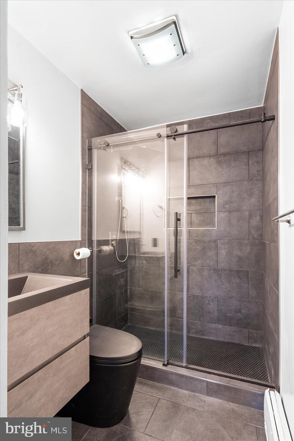 303 Miles Road Essex, MD 21221 - Photo 24 of 37 a bathroom with a shower a toilet and sink