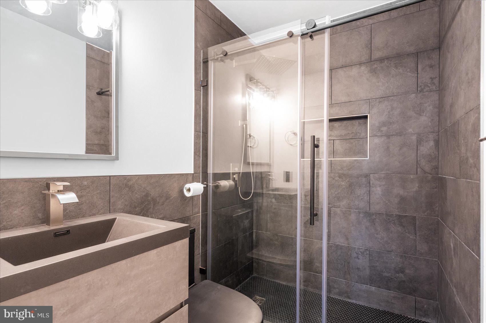 303 Miles Road Essex, MD 21221 - Photo 25 of 37 a bathroom with a shower and a sink