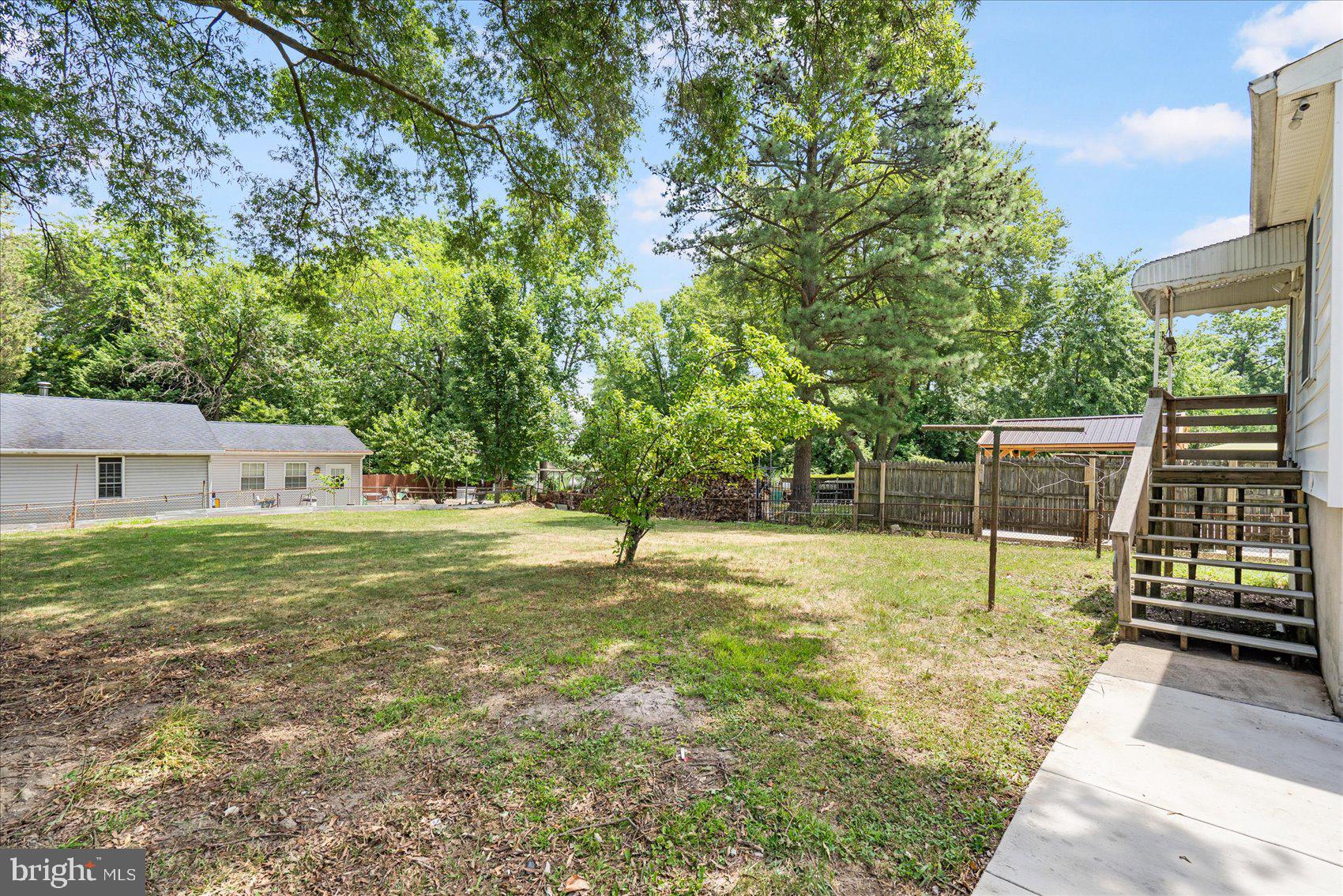 303 Miles Road Essex, MD 21221 - Photo 33 of 37 a view of a backyard with a garden and large trees
