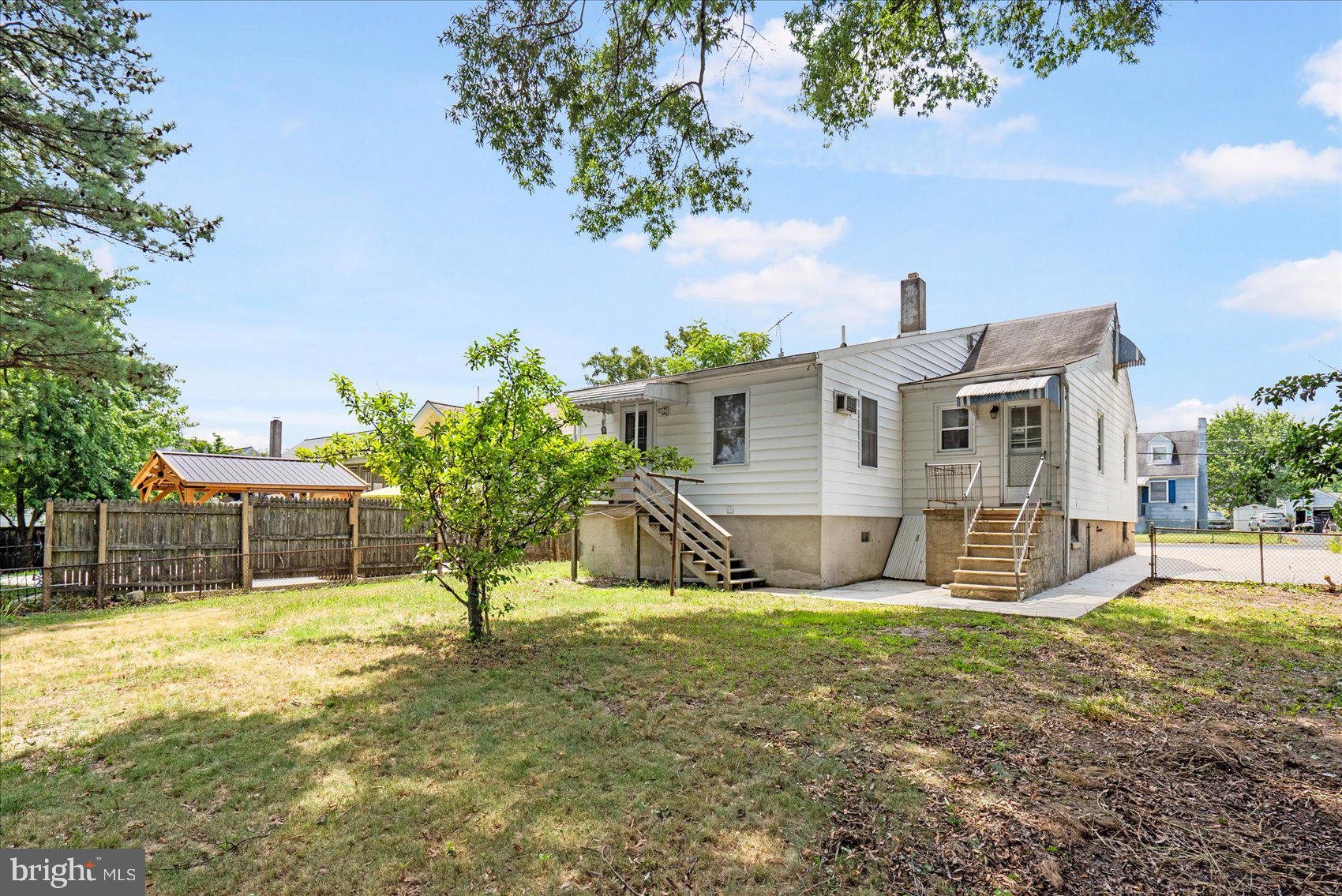 303 Miles Road Essex, MD 21221 - Photo 34 of 37 a view of a house with backyard and a tree