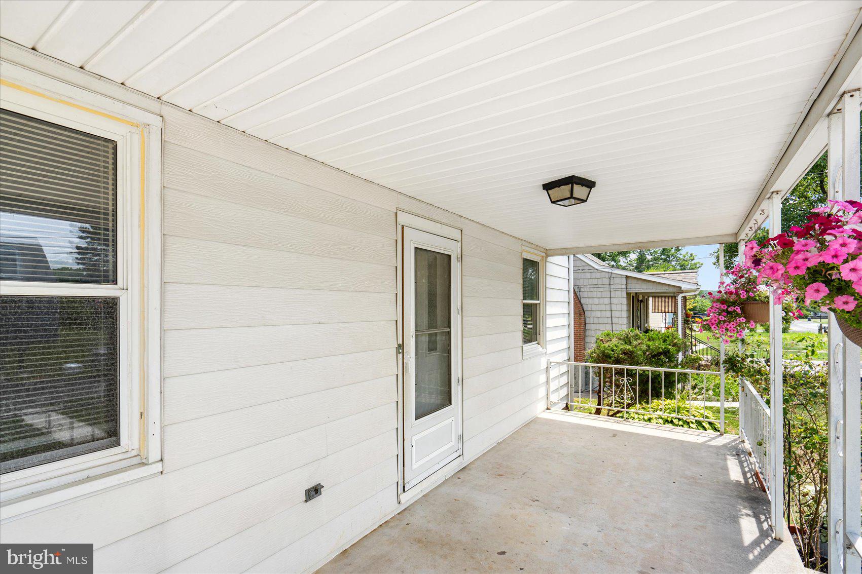 303 Miles Road Essex, MD 21221 - Photo 4 of 37 a front view of a house with a porch