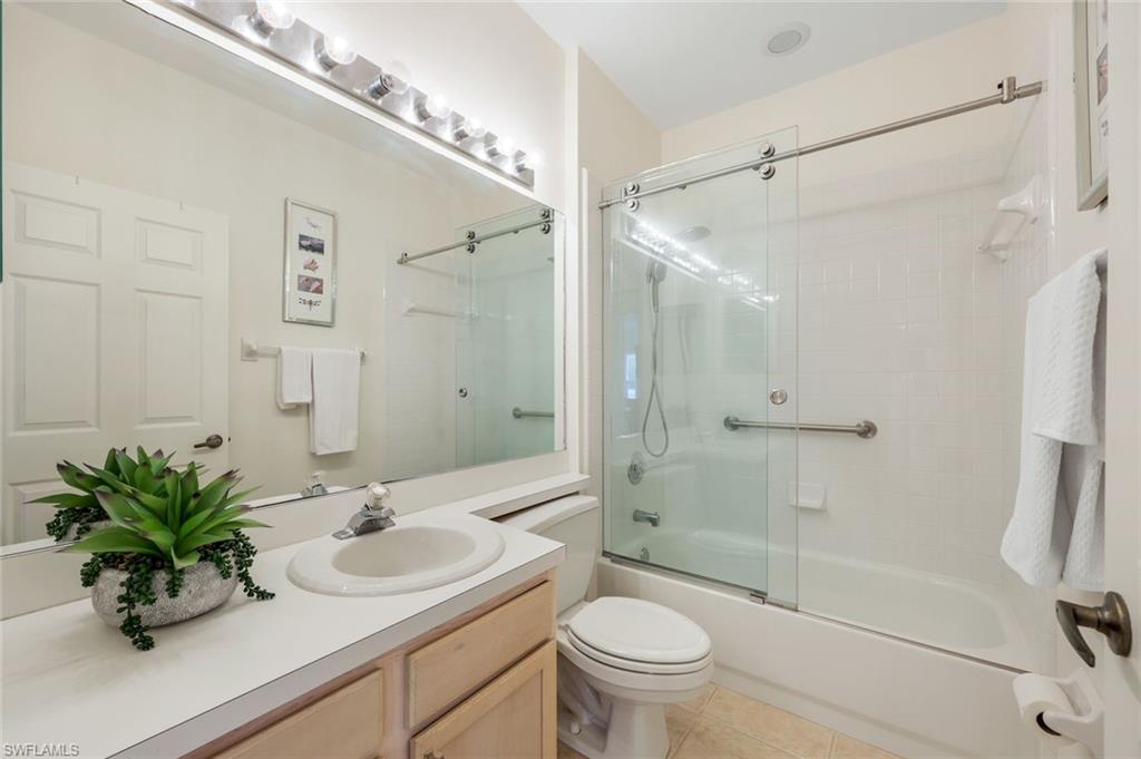 437 Wiggins Lake Court, Unit 201 Naples, FL 34110 - Photo 16 of 24 a bathroom with a sink toilet and shower