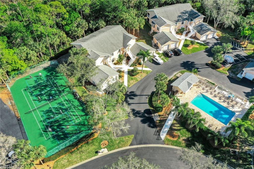 437 Wiggins Lake Court, Unit 201 Naples, FL 34110 - Photo 23 of 24 an aerial view of residential house with outdoor space and trees all around