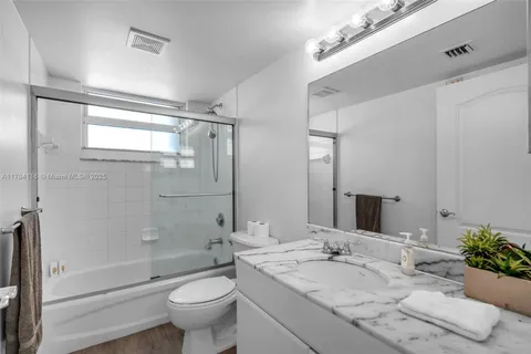 a bedroom with a bed and glass window